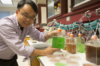 Dr. Chen holding a bottle.