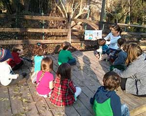 Reading outside at Audubon Pre-K