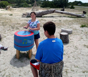 Girl playing a hand painted drum