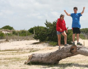 Girl & boy balancing on log