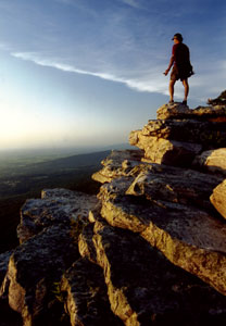 Person standing on the edge of a cliff enjoying the view