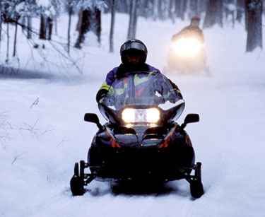 Snowmobiling on a snowy trail