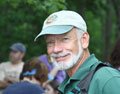 Image of man wearing baseball cap and smilling.