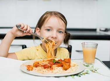 Child eating venison due to Farmers & Hunters Feeding the Hungry